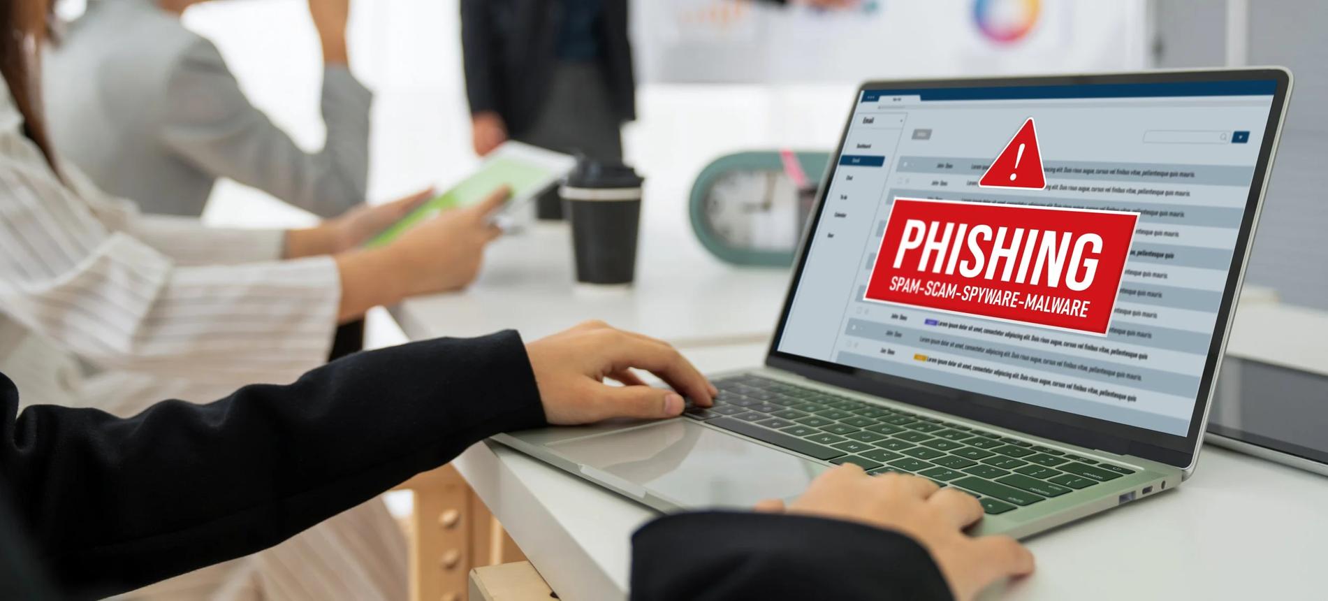 Person checking a suspicious parcel delivery email on a laptop while enjoying a cup of tea at home.